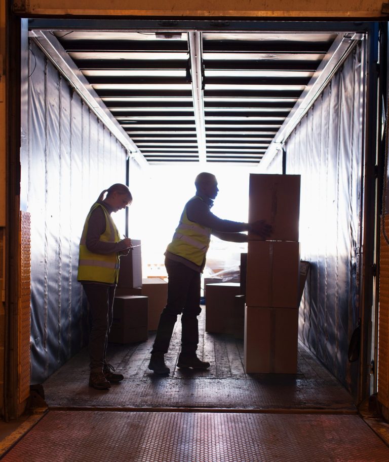 Workers loading boxes into truck Workers loading boxes into truck
